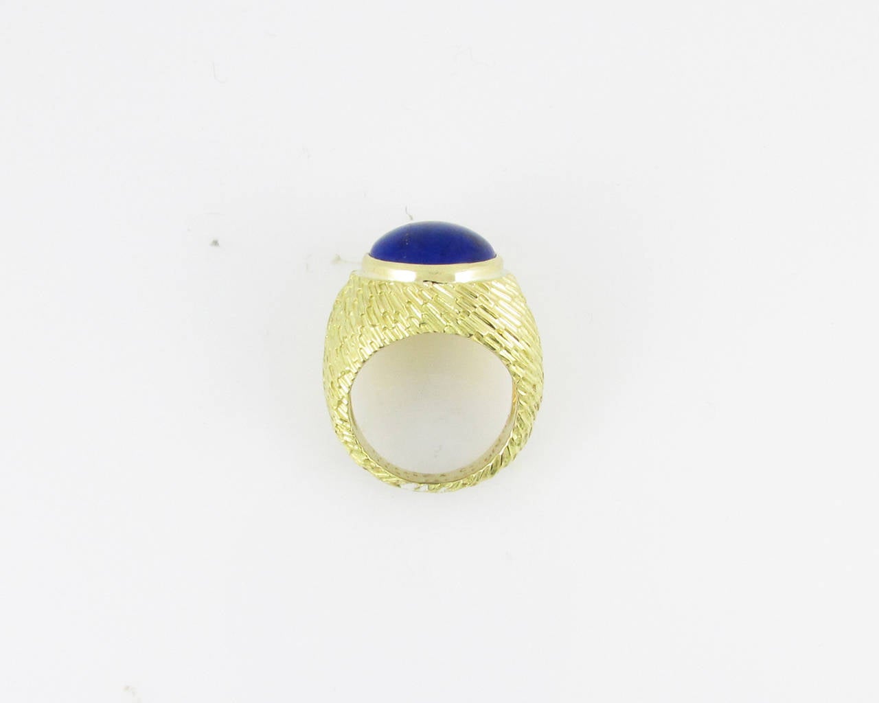 18KT yellow gold and  cabochon lapis lazuli ring having a heavy textured finish. Signed Tiffany & Co., France. Engraved 