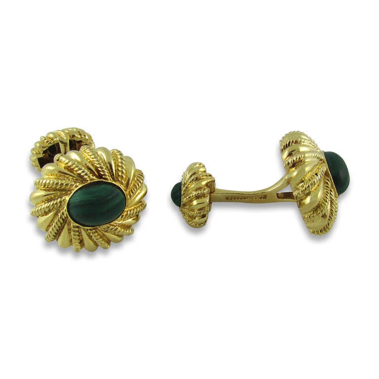 18KT yellow gold cufflinks set on both sides with an oval cabochon malachite. Curved stiff bar connector. Signed Schlumberger for Tiffany & Co.