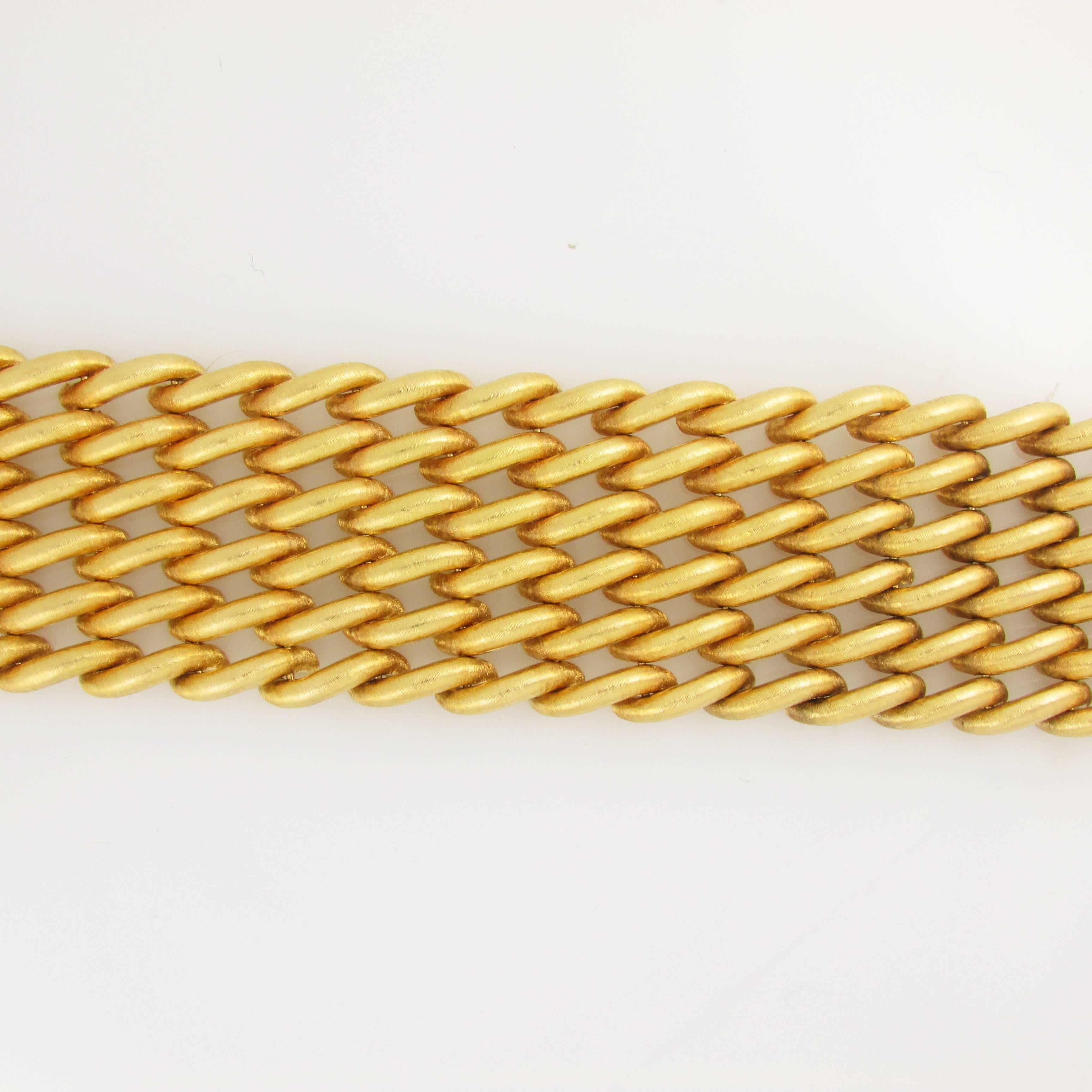 18KT yellow gold, wide, textured, link bracelet. 1.5 inches wide, 7.75 inches long. Signed M. Buccellati. 