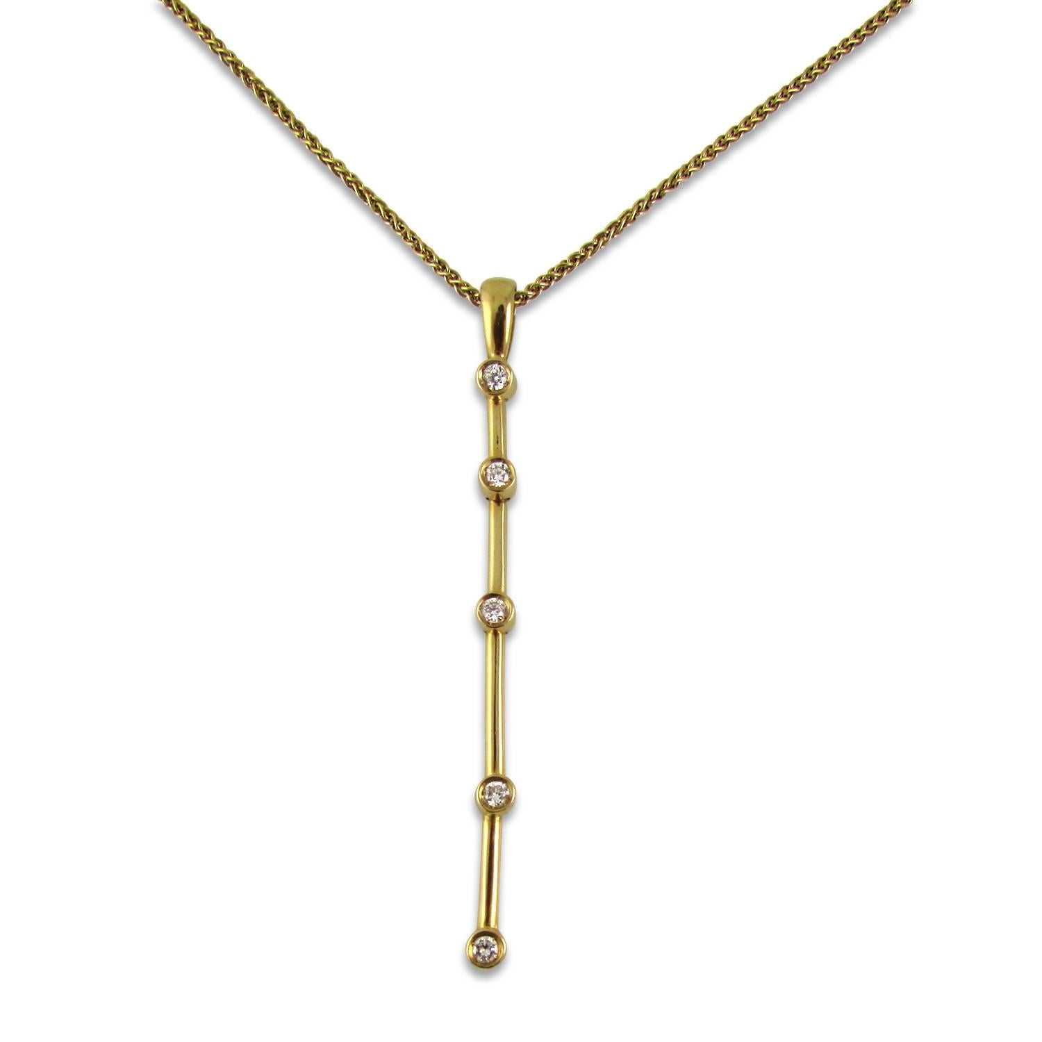  18KT yellow gold and diamond pendant bezel-set with 5 round diamonds. Pendant is 2.25 inches long and comes on a 20 inch 14KT yellow gold Italian chain. Pendant is signed Ilias Lalaounis Greece. 