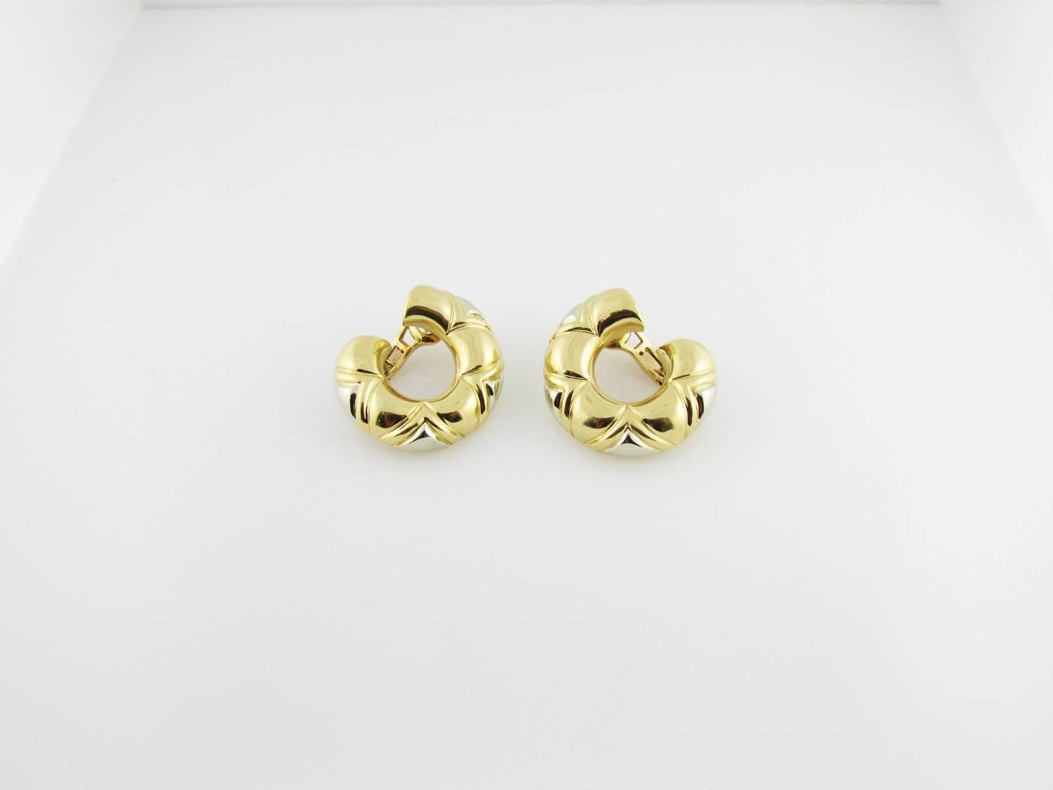 18KT two-tone yellow and white gold half-hoop earrings. Clipbacks and posts.
Signed Bulgari. c2000s. 