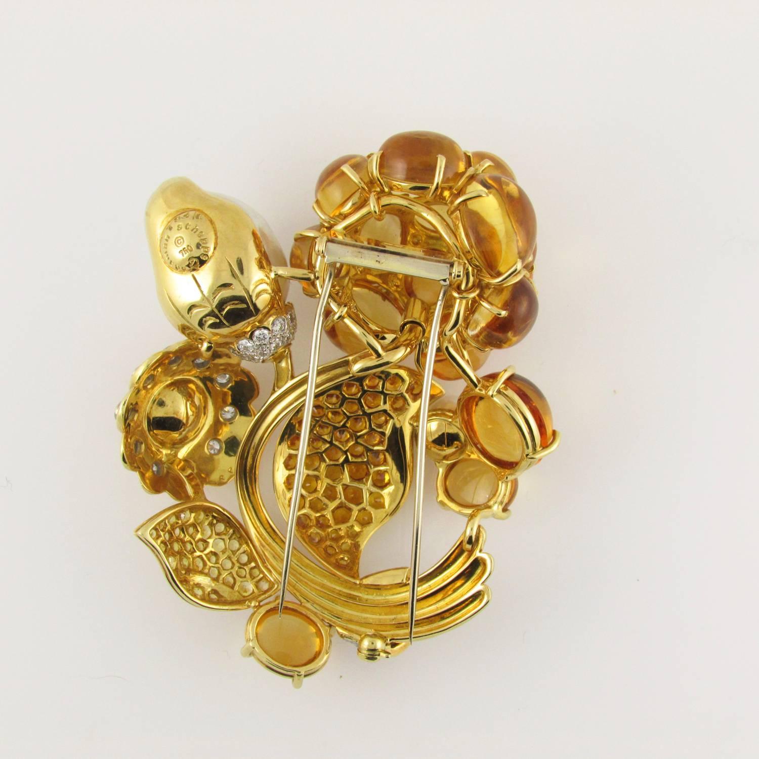 18KT yellow gold flower brooch set with cabochon citrines and having a white baroque pearl flower bud;  leaves pave set with yellow sapphires of various shades; accented with diamonds.   2 3/4”  X  2 1/4”
Signed Seaman Schepps.