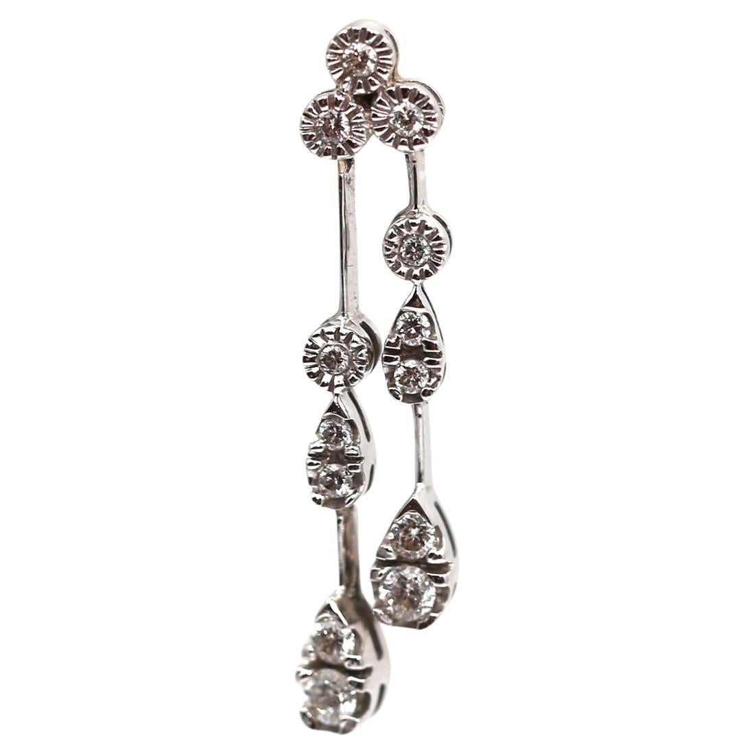 Diamond Drop Earrings 18K White Gold, created around 2000.
A Pair Of Diamond Drop Earrings in 18ct white gold, each set with a trio of round brilliant cut diamonds suspending two rows of further round brilliant cut diamonds. The links are not fixed