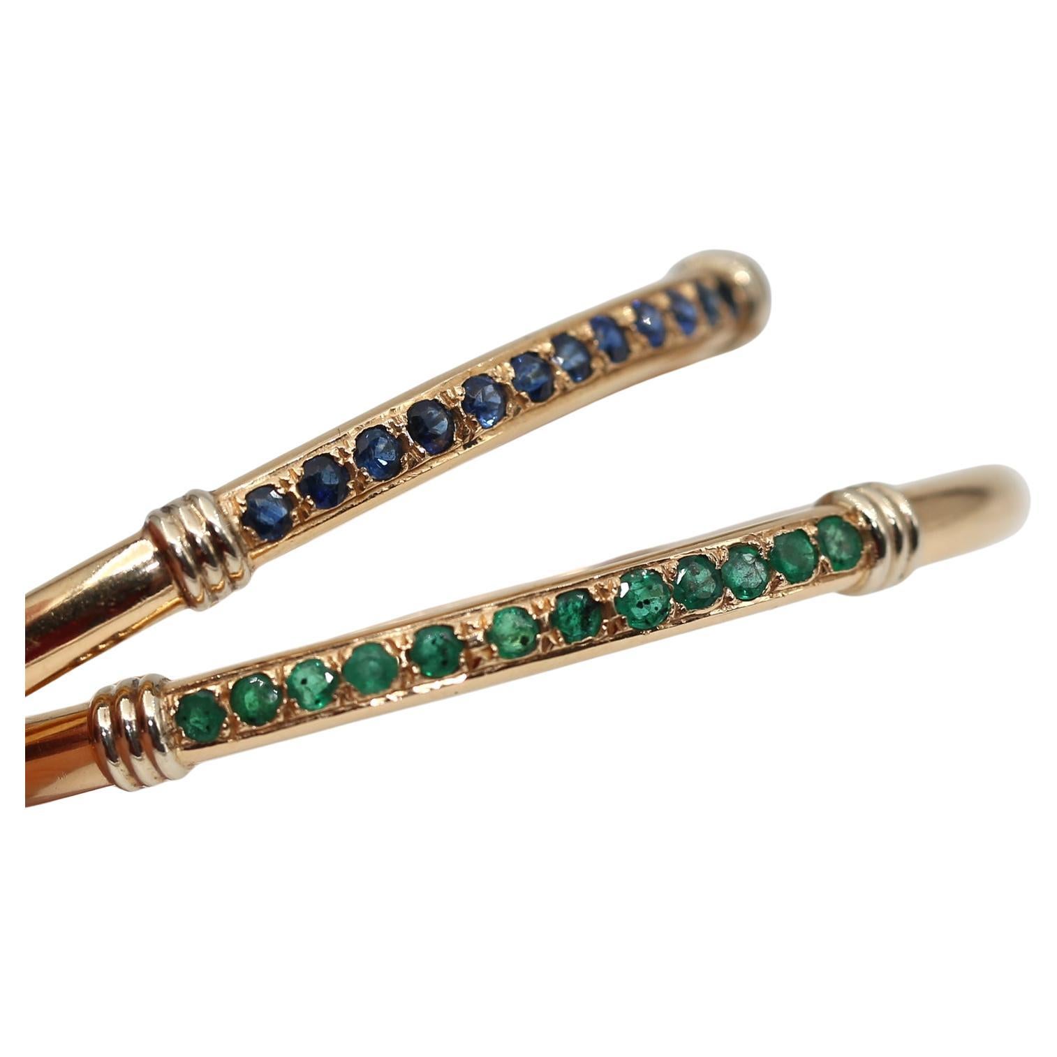 Each bracelet is set with a row of 12 round-cut Emerald and Sapphire stones respectively.
Each bracelet has a fine heavy weight to it and they bling nicely when worn together on one hand. The pair is a fashion statement and a great addition to a