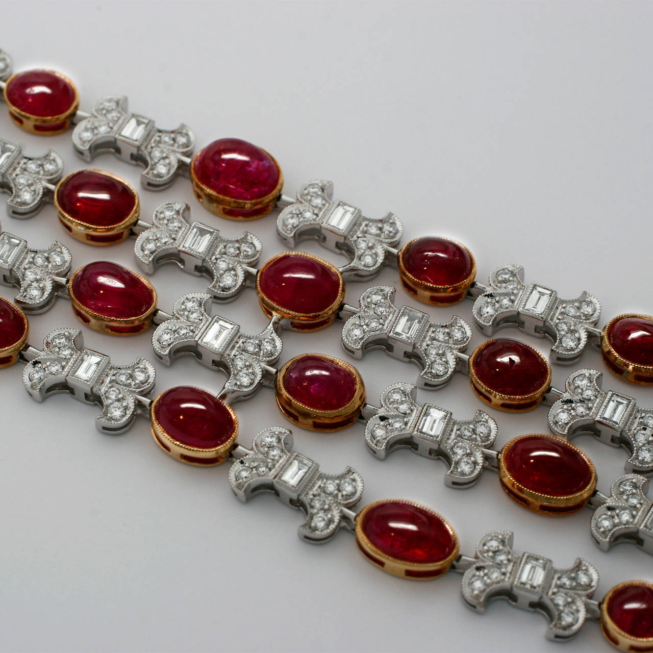 Platinum and 18k Yellow Gold Bracelet with an Amazing Collection of Matching  Cabuchon Burma Rubies (36r=44.16ctw) with Beautiful Diamond Bows (288 Round Brilliant Diamonds=3.47ctw and 26 Baguette Diamonds=2.60ctw H/VS) weighing an incredibly light