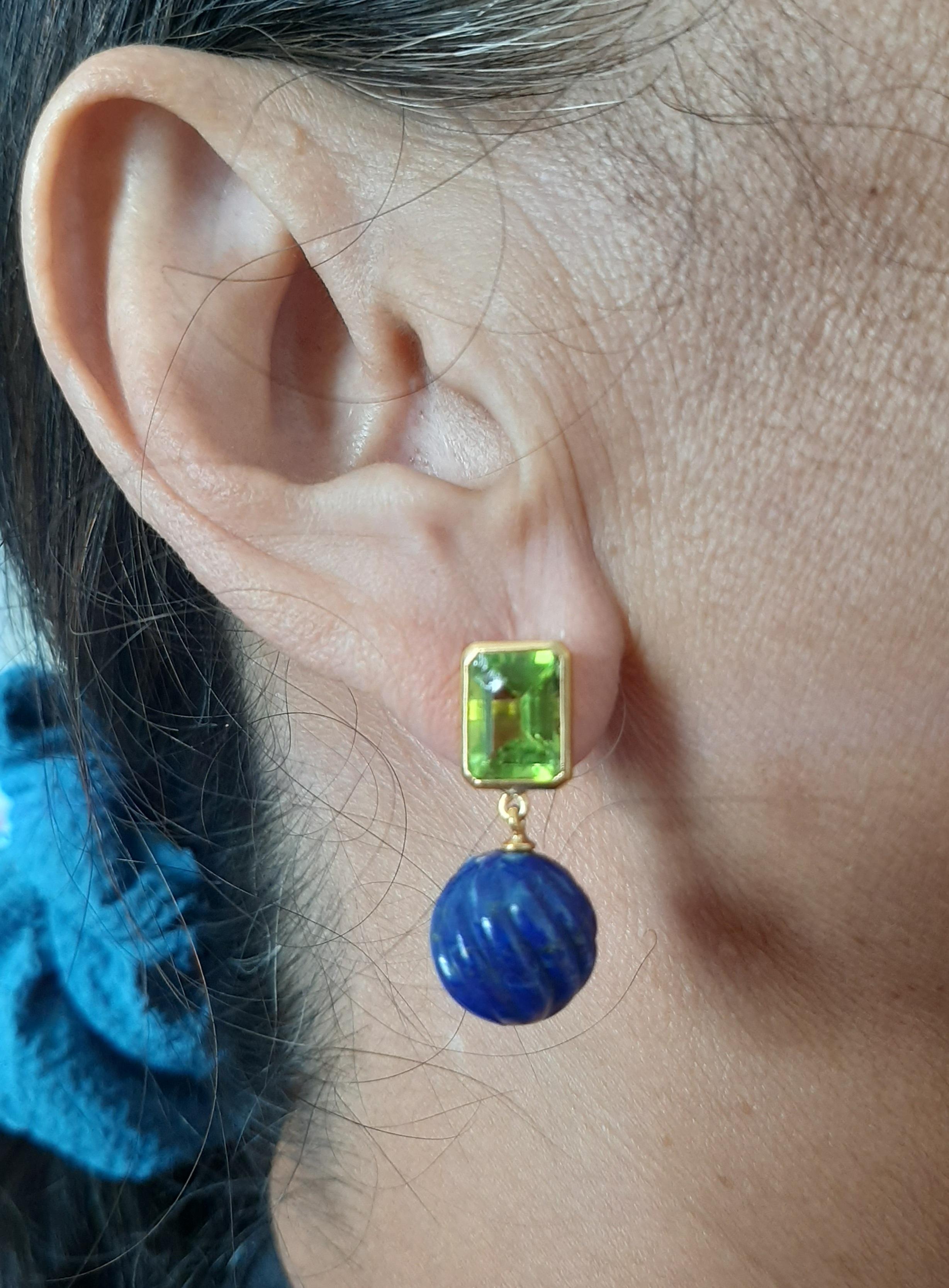 Simple chic  earrings with a pair of Faceted  Octagon Shape Peridot size 10 x 12 mm set in 14 kt solid yellow gold on the top and 2 Genuine Carved Lapis Lazuli round beads of  12 mm in diameter on the bottom.

In 1978 our workshop started in Italy