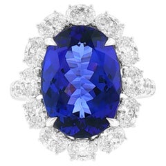 Oval shape 6.69ct Tanzanite and Diamond Halo setting Modern Ring in 18K Gold