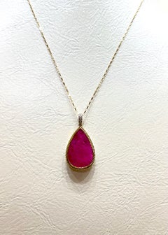 Ruby with Diamond Pendant set in 18K Gold Settings