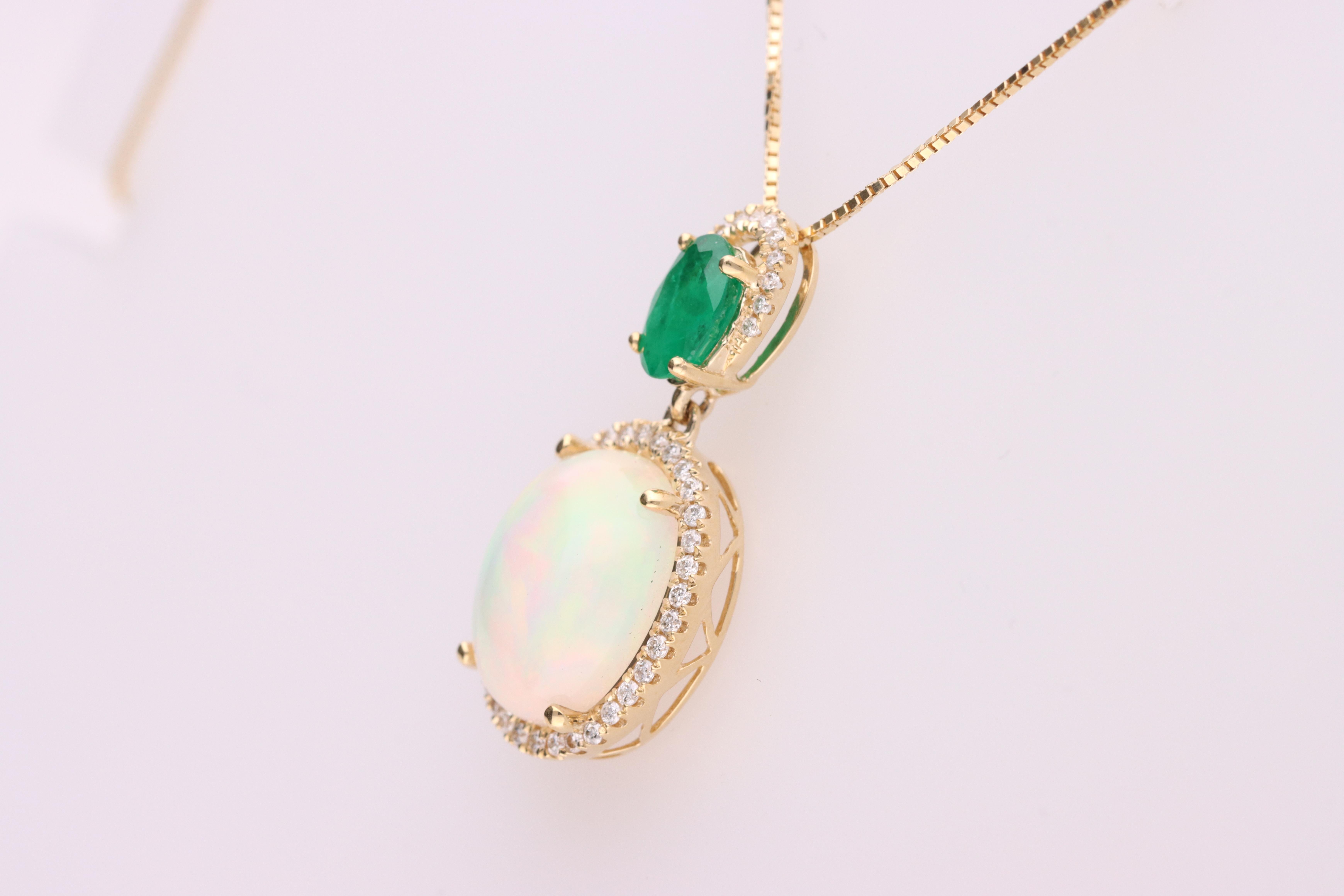 A luxurious pendant necklace showcasing a vibrant oval-cut emerald set above a mesmerizing opal cabochon, both surrounded by sparkling halos of brilliant white diamonds. It features a 4x6 mm Emerald of 0.4ct, a 9x11mm Ethiopian Opal of 2.5ct and 46