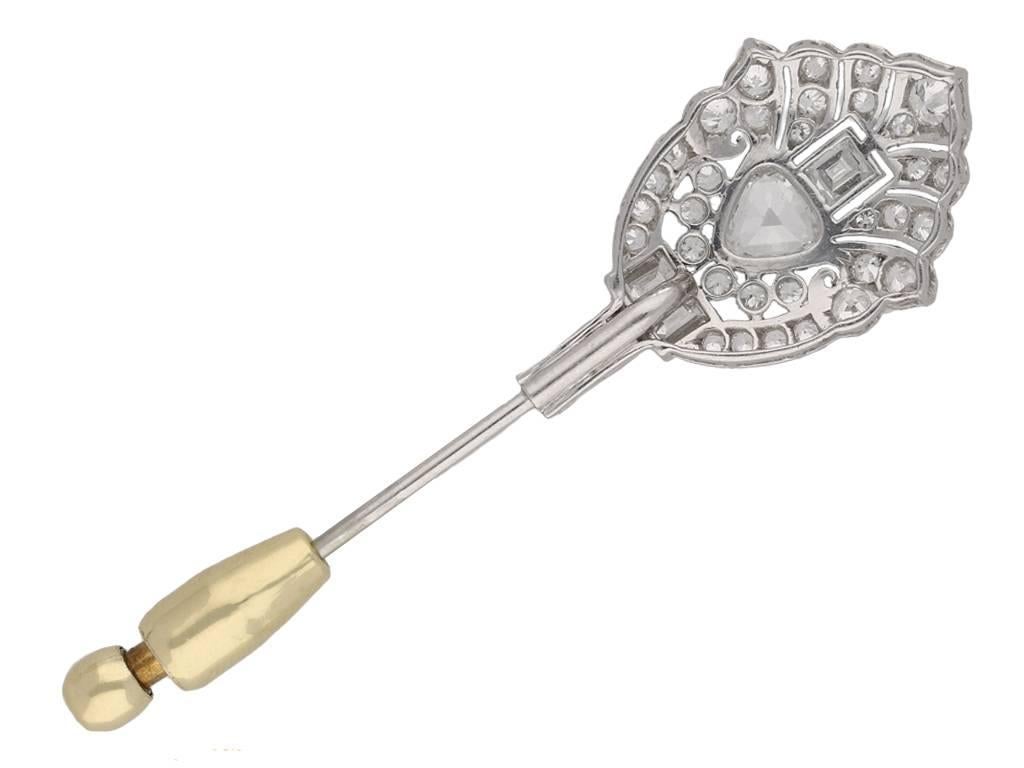 Art Deco diamond pin. Centrally set with a drop shape old cut diamond in an open back millegrain setting with a weight of 0.70 carats, surrounded by five rectangular baguette cut diamonds in open back millegrain and channel settings with a combined