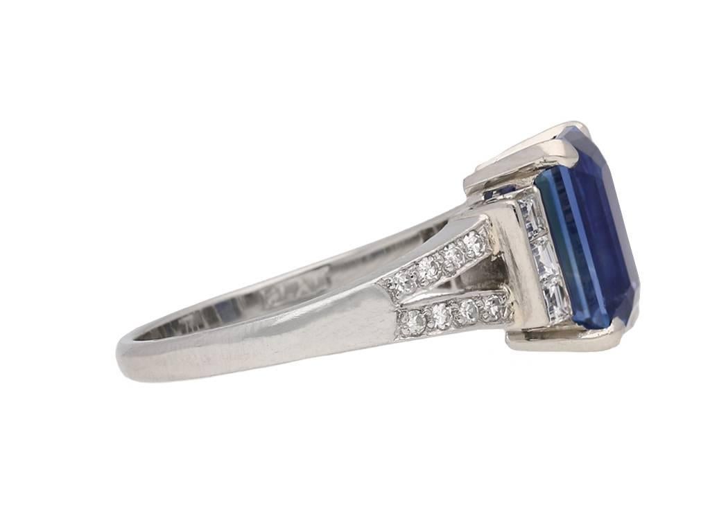 Art Deco Ceylon sapphire and diamond ring. Set to centre with a octagonal emerald-cut natural unenhanced Ceylon sapphire in an open back claw setting with an approximate weight of 3.44 carats, flanked by six square step cut diamonds in open back