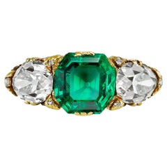 Victorian Colombian emerald & diamond carved three stone ring, English, c. 1890.