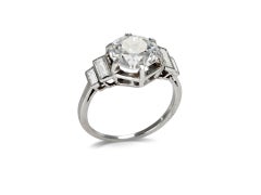 Old Cut diamond flanked solitaire, French, early 20th Century.