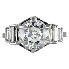 Old Cut diamond flanked solitaire, French, early 20th Century.