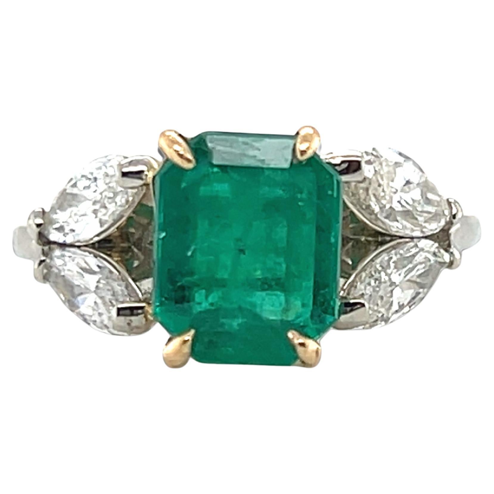 Indulge in the timeless elegance of this high-end ring, featuring a stunning emerald cut green natural earth-mined emerald with Colombian provenance. The vibrant emerald is securely set in an 18kt yellow gold basket with four prongs, ensuring its