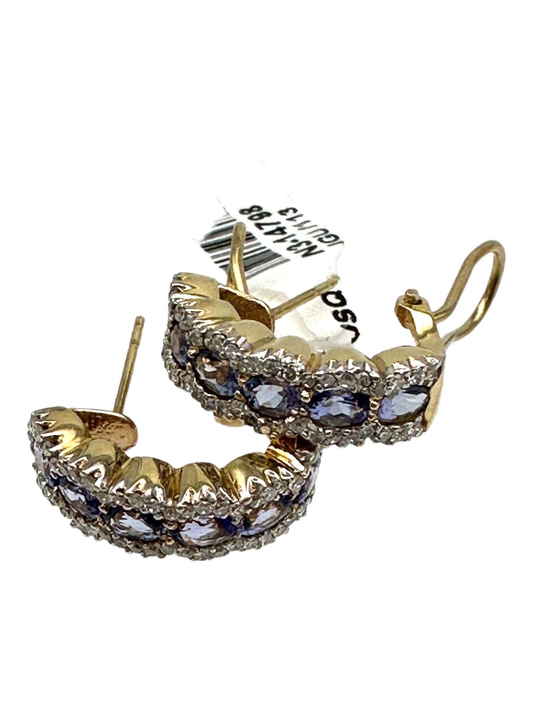 Sparkling, oval-shaped tanzanites are set with surrounding diamonds on a hoop for pierced or clip-on use. The tanzanites are a gorgeous color set in diamonds surrounding each stone. 
The earrings are 3/4 inches in length and have a sturdy
