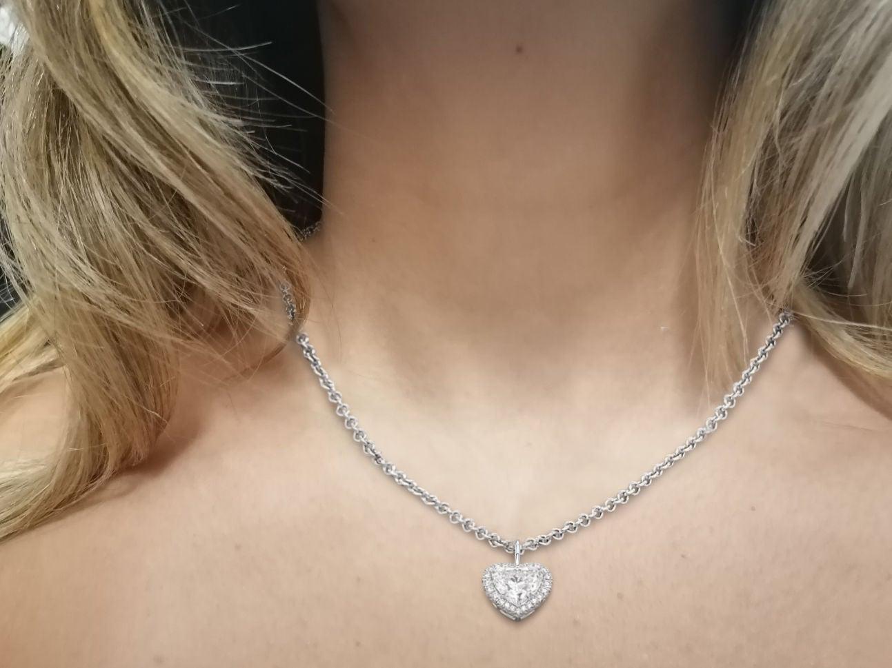 We present this magnificent pendant with a GIA certified heart shape diamond of 3.75 carats
Around this heart is a circle of round cut diamonds.
The total carat weight is approximately 3.75 carats.

The 18k white gold chain is included.