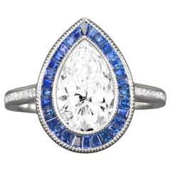 Anello aureolato con diamante taglio pera e zaffiro blu certificato GIA da 1,50 carati