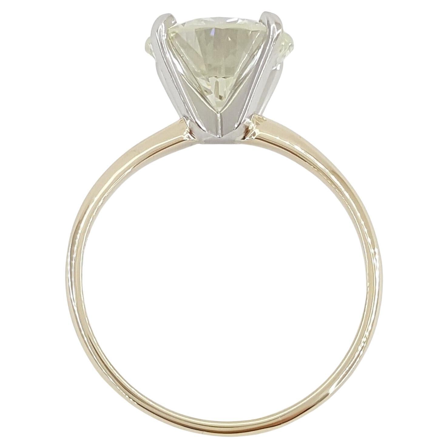  exquisite 14K Yellow Gold & Platinum Solitaire Engagement Ring adorned with a captivating 3.04 carat Round Brilliant Cut Diamond, destined to symbolize everlasting love and commitment.

This elegant ring, weighing 3 grams and sized at 7, features a