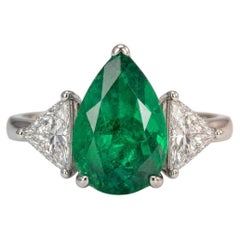6.10 Carat Vivid Green Colombian Pear Shape Emerald Diamond Three Stone Ring