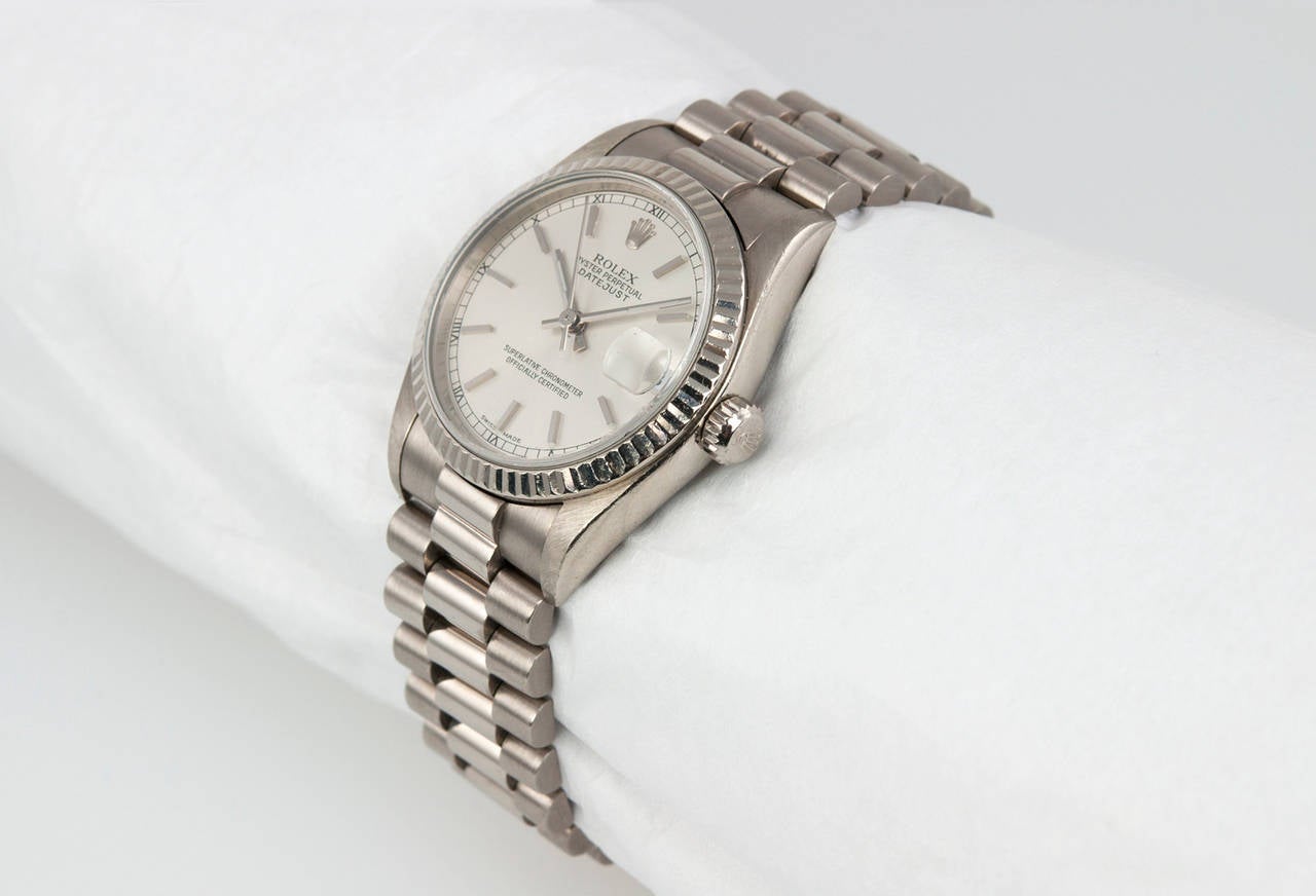 Rolex 18k white gold mid-side Datejust wristwatch, Ref. 78279. This watch features a sapphire crystal, white gold fluted bezel, locking waterproof crown, silvered satin dial with baton indexes, white gold president bracelet. 1999.

This watch