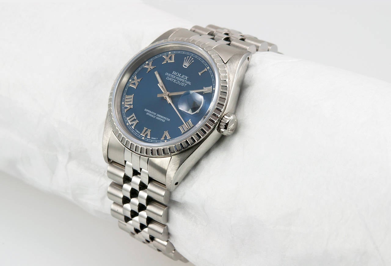 Rolex stainless steel Datejust wristwatch, Ref. 16220, 1991. This classic Datejust has a sapphire crystal, a blue dial with Roman numerals, a steel fluted bezel, locking waterproof crown, Jubilee bracelet. The case measures 36 mm in width.

This
