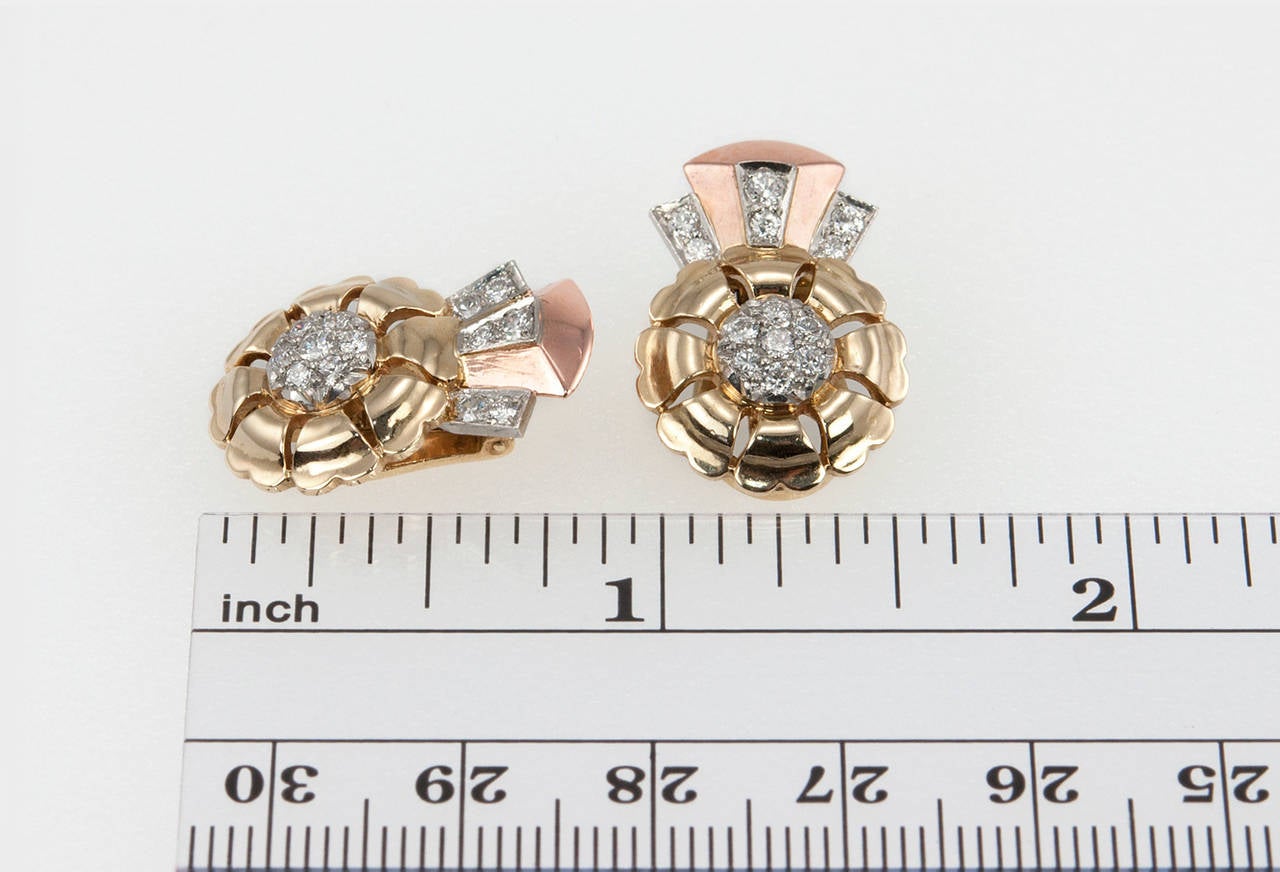 Retro gold and diamond clip-on earrings in the style of a ribbon design in 14 karat yellow, white, and pink gold. The earrings have 26 round diamonds (full and single cut diamonds), which total approximately 0.50 carats in diamonds.
Circa