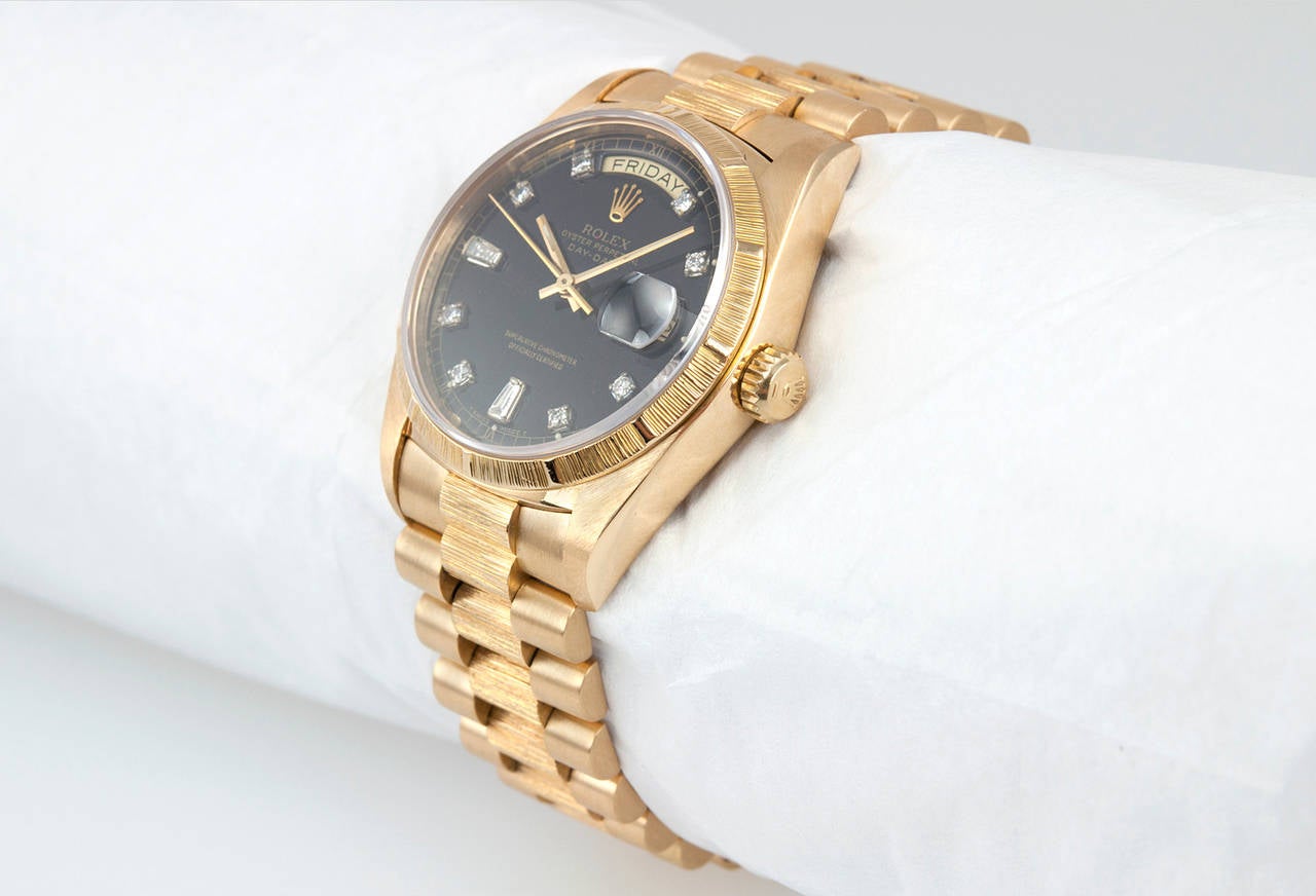 Rolex President wristwatch in 18 karat yellow gold with a bark finish, reference 18038. This classic 1986 President features a custom black diamond dial, a scratch resistant sapphire crystal, an automatic movement with date, locking, waterproof