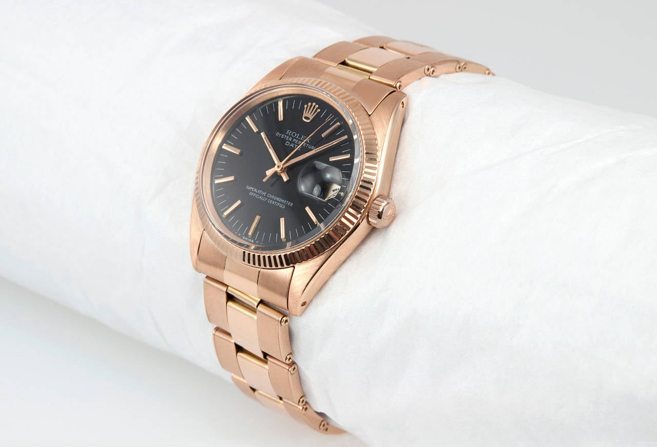 Rolex Date wristwatch in 18 karat pink gold, reference 1503-5. This beautiful Rolex is from 1963 and features a pink gold riveted oyster bracelet, an original black dial with a pink gold fluted bezel, and a locking waterproof crown. Case measures 34