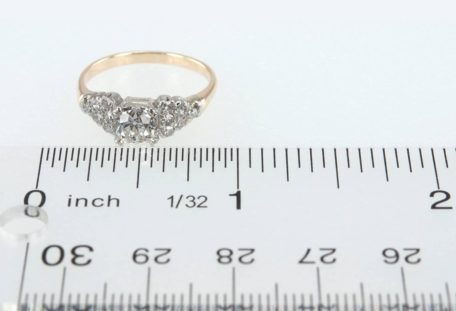 A beautiful 14 karat gold engagement ring featuring an old cushion cut center diamond that is 0.91 carats, H in color and SI1 in clarity (per EGL cert) along with 12 single cut side diamonds, 6 on each side. Circa 1930s.  The ring has a low profile