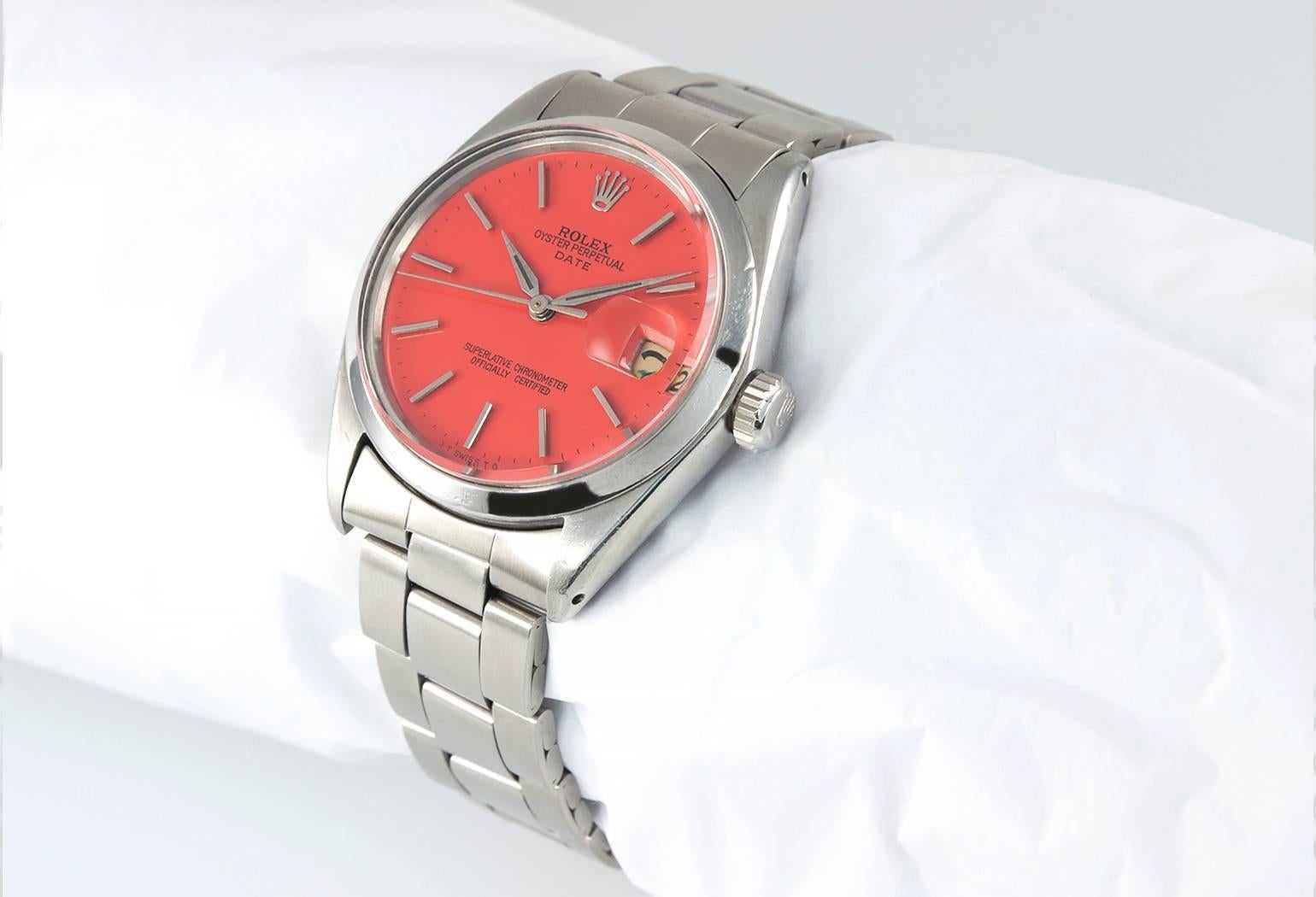 Rolex Date wristwatch in stainless steel reference 1500. This classic Rolex watch features a custom colored red coral dial, a stainless steel smooth bezel, a waterproof stainless steel crown, oyster riveted steel bracelet, plastic crystal, automatic