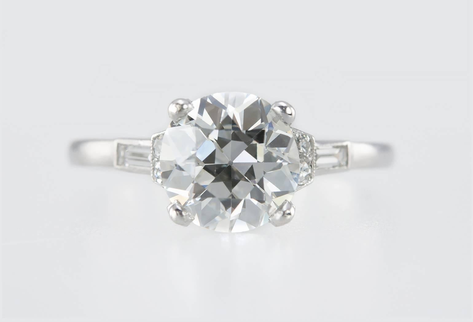 A gorgeous Art Deco diamond and platinum engagement ring from circa 1930s.  This ring features a 1.68 carat Old European Cut diamond that is I in color and VS1 in clarity (per GIA certificate).  There are an additional 4 round diamonds and 2