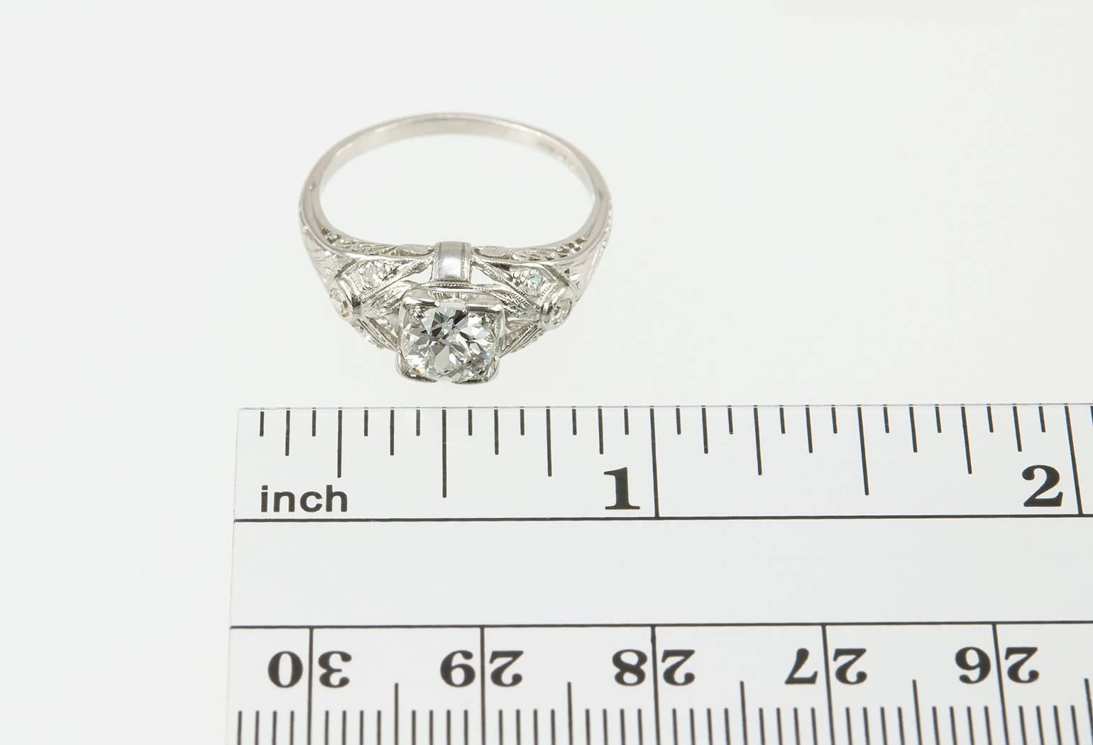 This vintage Art Deco platinum and diamond engagement ring features a 0.64 carat Old European Cut diamond in the center that is G in color and VS2 in clarity (per EGL certificate). The ring is further accented with an additional 6 side diamonds that