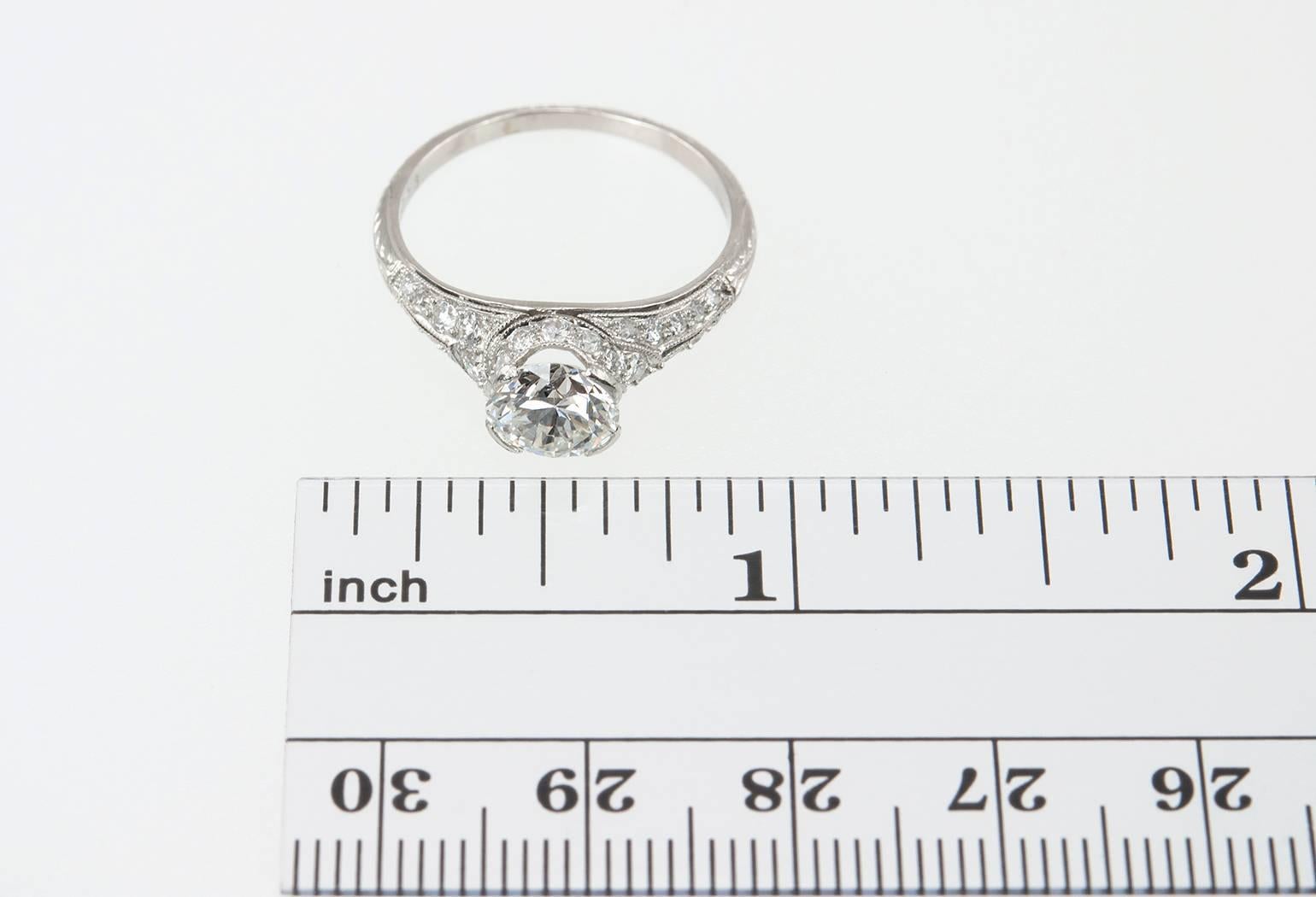 A stunning Edwardian engagement ring! This ring features an Old European Cut 1.20 carat diamond that is F in color and VS1 in clarity (per GIA certificate).  The ring is set with round diamonds throughout, which make the ring really sparkle! The