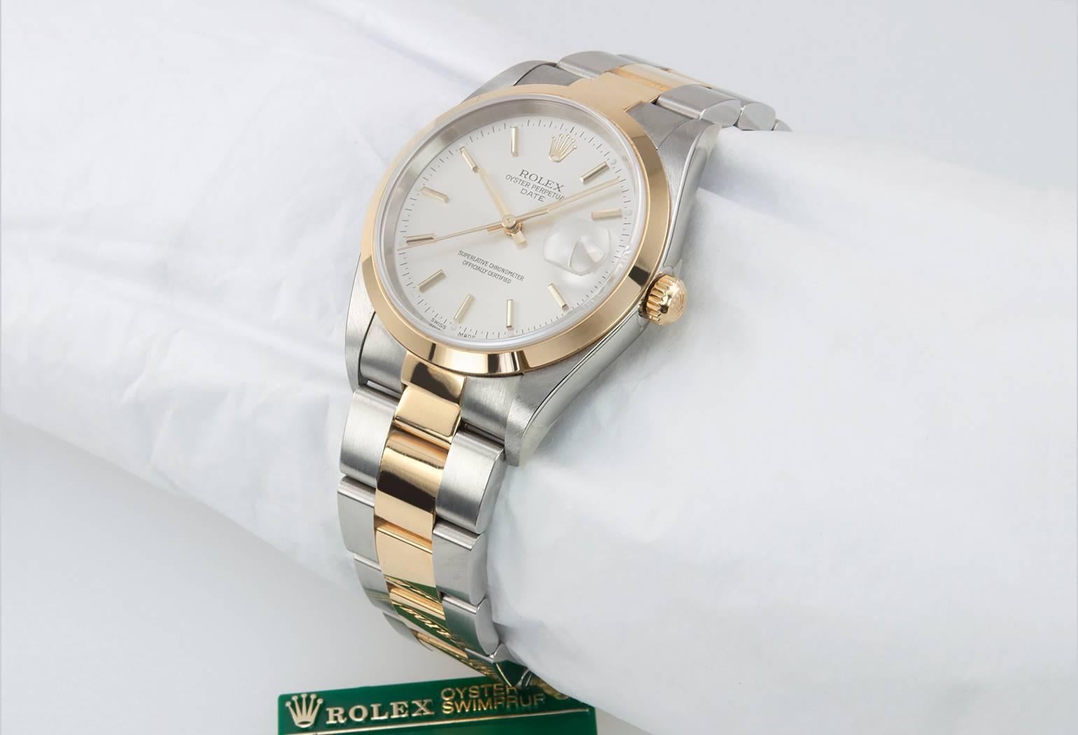 Rolex Oyster Date two-tone wristwatch in 18 karat yellow gold and stainless steel, reference 78353. This classic Rolex features an 18 karat yellow gold smooth bezel with a yellow gold locking crown, a white dial, and an 18 karat yellow gold and