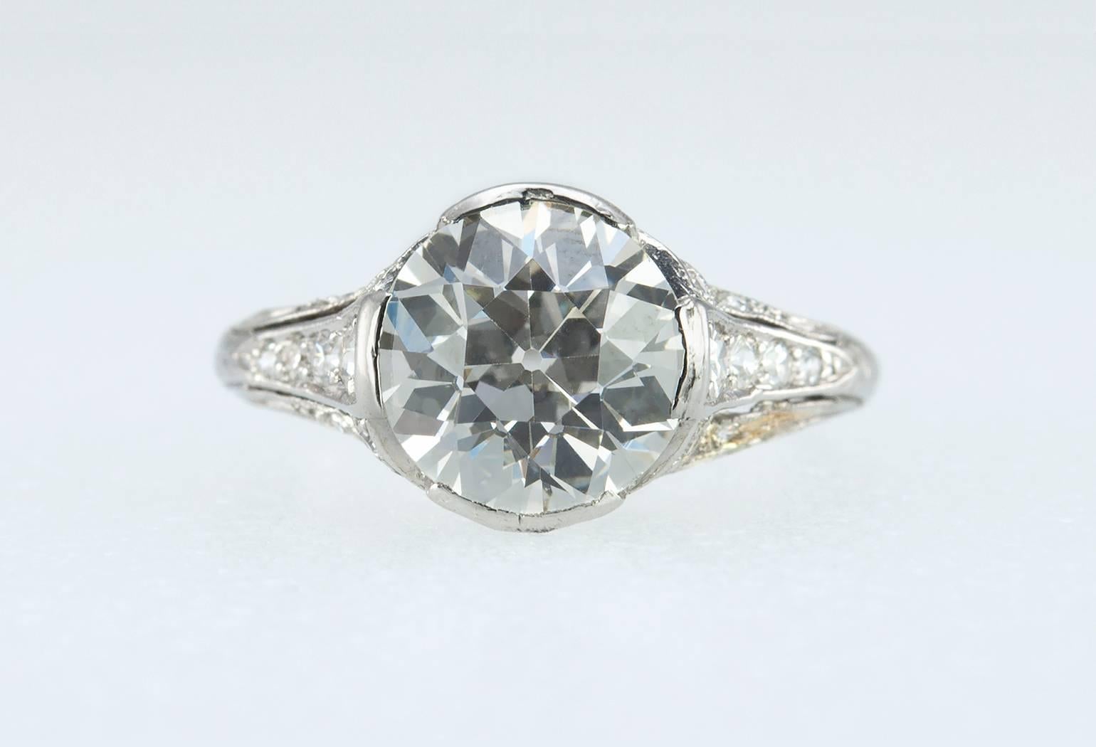 A gorgeous antique Edwardian platinum diamond engagement ring! This ring features a center 2.20 carat Old European Cut diamond that is K in color and VS1 in clarity (per EGL certificate).  There are an additional 36 single cut diamonds set