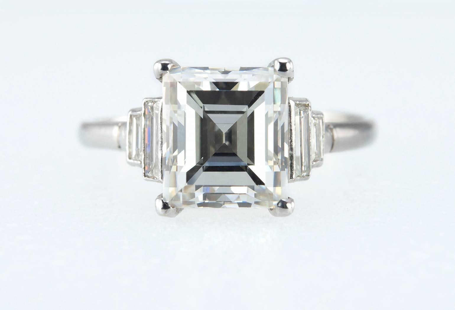 A stunning and classic Art Deco engagement ring! This beautiful ring features a center 2.90 carat emerald cut diamond that is J in color and VS1 in clarity (per GIA certificate). There are 4 baguette diamonds (2 on each side) that total