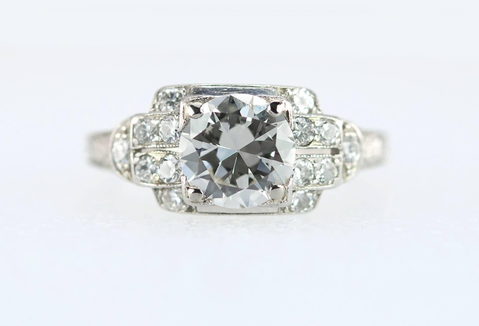 An Art Deco diamond and platinum engagement ring from circa 1930.  This beautiful ring features a 1.02 carat Old European Cut diamond center that is I in color and VS2 in clarity (per GIA certificate), which is bead set in a square mounting.  An