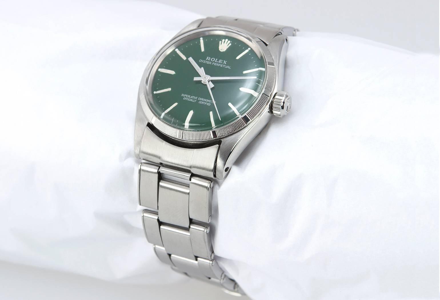 Rolex Oyster Perpetual midsize stainless steel watch, reference 6549. This beautiful Rolex features a stainless steel case, stainless steel fluted bezel, dark green custom dial, Oyster style riveted bracelet, plastic crystal, locking waterproof