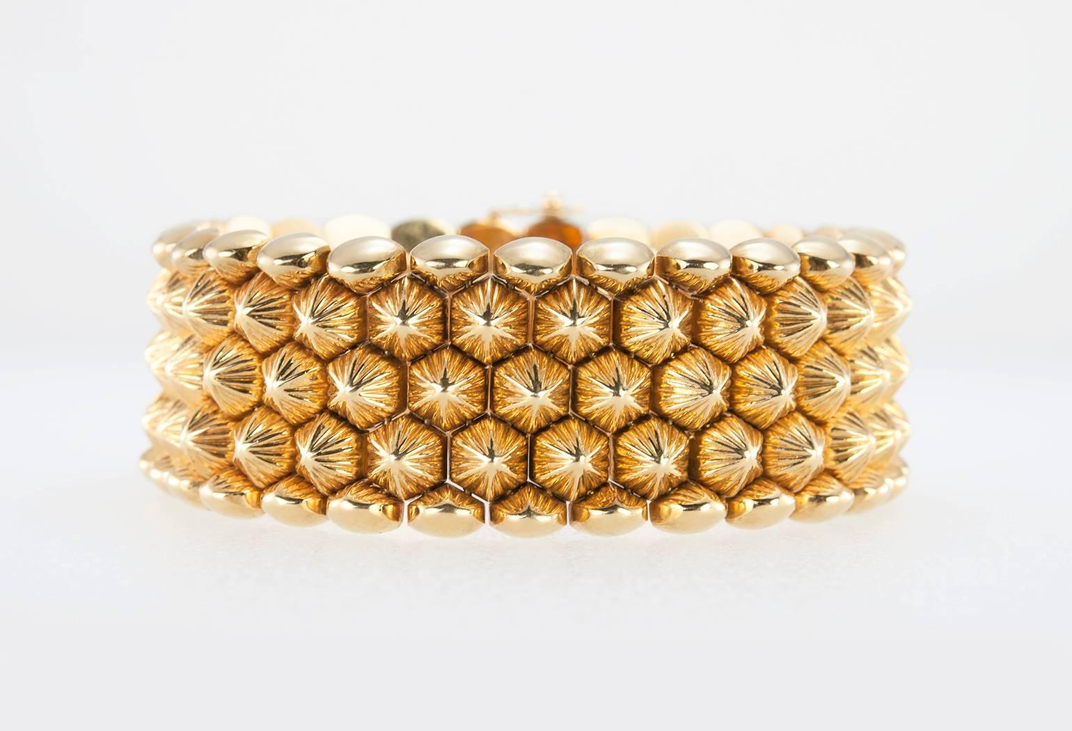 A very cool Retro gold link bracelet in 18 karat orangey-yellow gold.  There first and last row have rounded, dome shaped links while the middle three rows have pointed, spikey dome on the textured gold links.  The back of the bracelet is smooth and