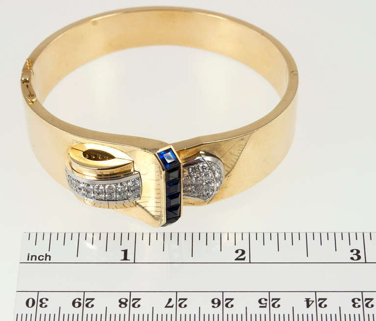 Retro chic!  Sapphires and diamonds adorn this great bangle.  1.60 carats of diamonds and 6 synthetic sapphires.  

The interior of the bangle measures 7 inches.