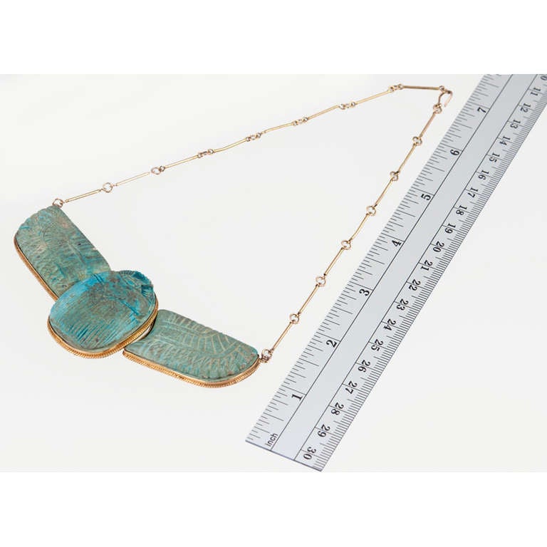 Egyptian styles are always in fashion for one reason...they are just so awesome! This is an Egyptian Revival faience winged scarab necklace in 14 karat gold from the turn of the century. Looks great on its own as well as layered with delicate gold