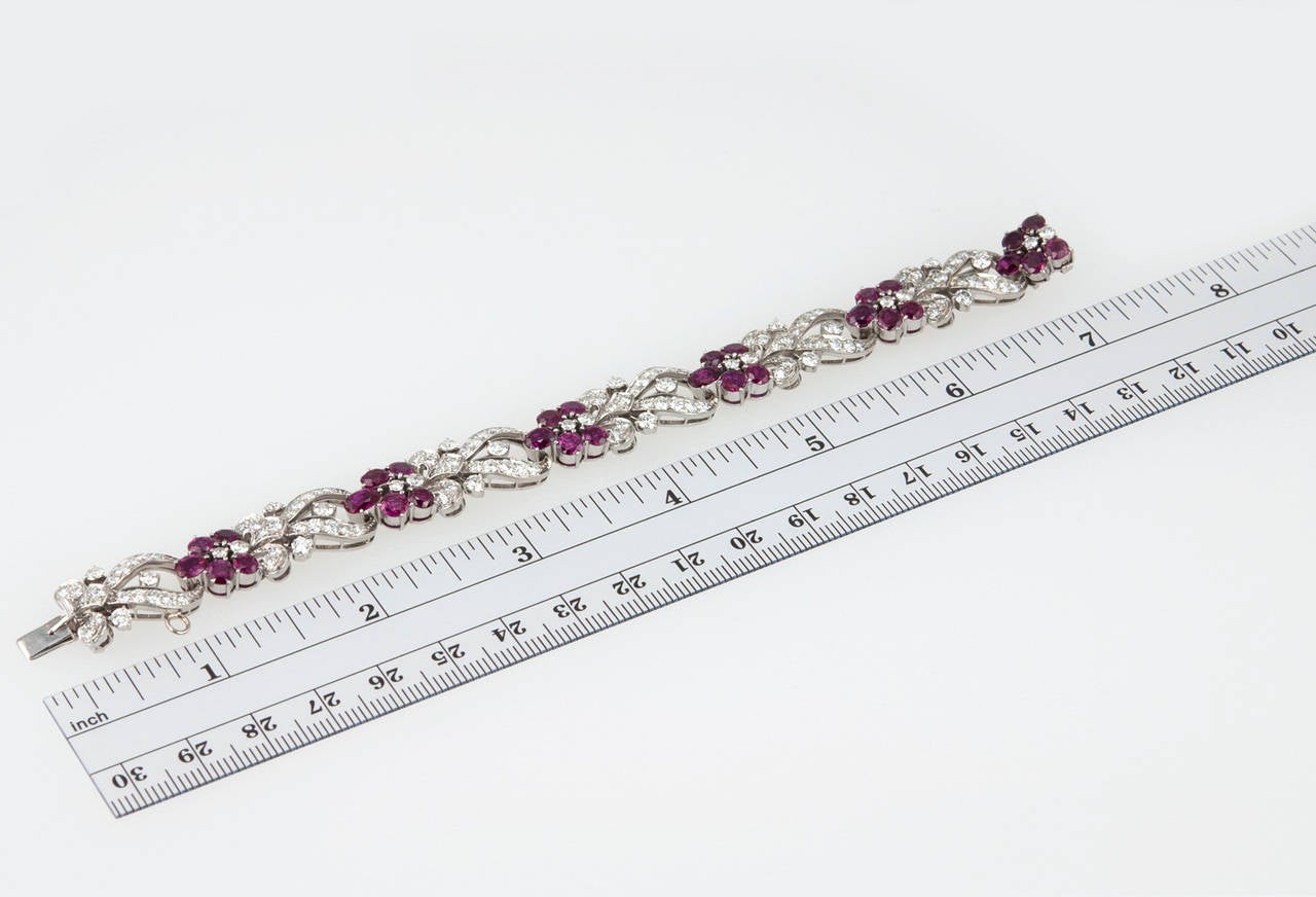 This stunning link bracelet was made by Tiffany & Co. in a floral motif and contains 30 natural rubies and approximately 6 carats of round brilliant diamonds. The bracelet was constructed in palladium, which leads us to believe it was made