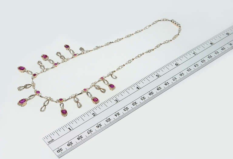 Feelin' the fringe! This lovely Edwardian fringe necklace with diamonds and rubies is set in platinum and 18 karat yellow gold, circa 1910. Millegraining detail surrounds the old european cut diamonds and rubies. 

Approximately 5 total carats in