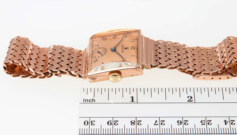 The pictures of this watch cannot capture the true beauty of this rare 14k rose gold Rolex square wristwatch with fancy link bracelet, Ref. 3512, circa 1934. Manual-wind, 17-jewel movement, an acrylic crystal, rose dial and black hands. The square