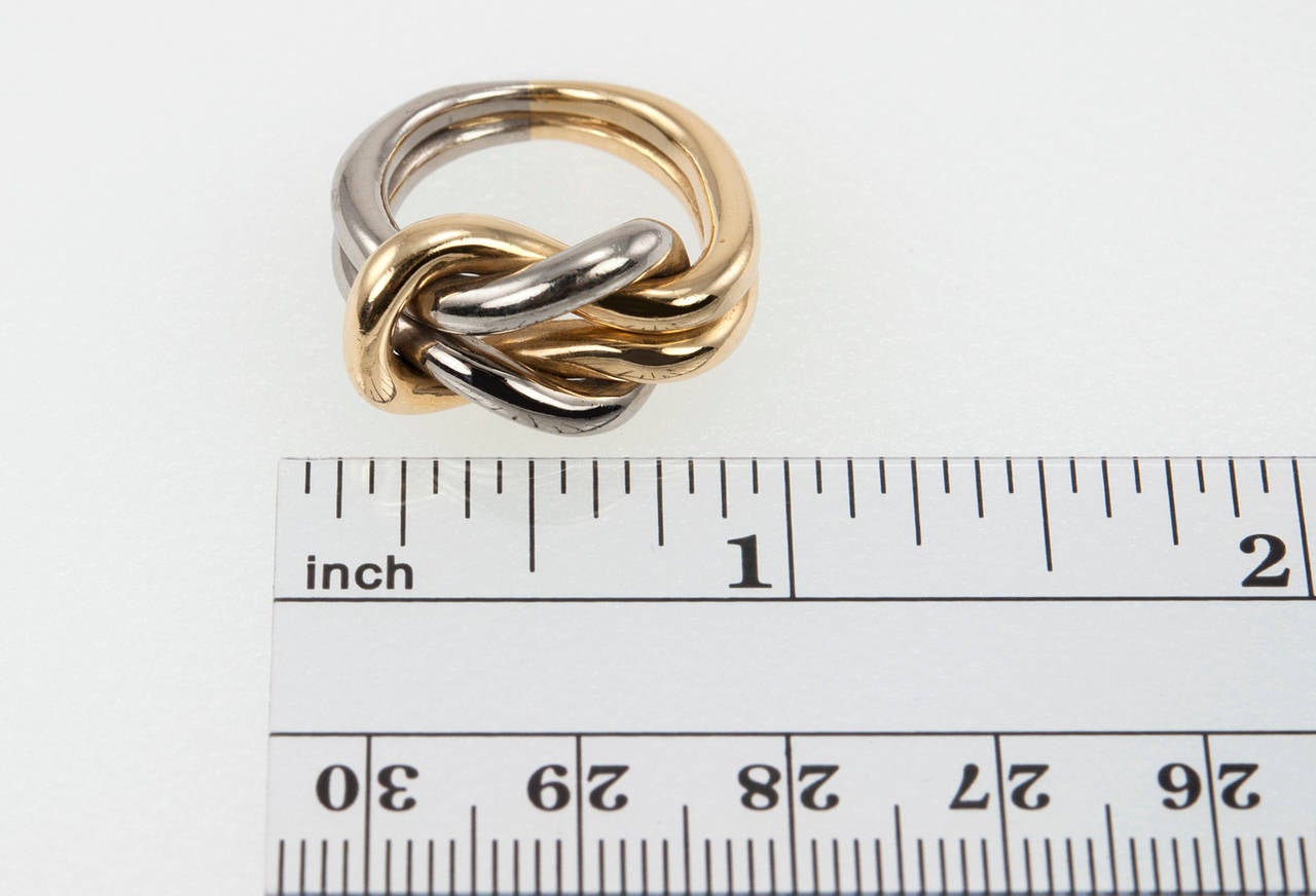 A chic Cartier knot ring in 18 karat yellow and white gold...a timeless ring you can wear with anything and everything!

Numbered and signed Cartier with French hallmark.

Currently a US size 4.25.