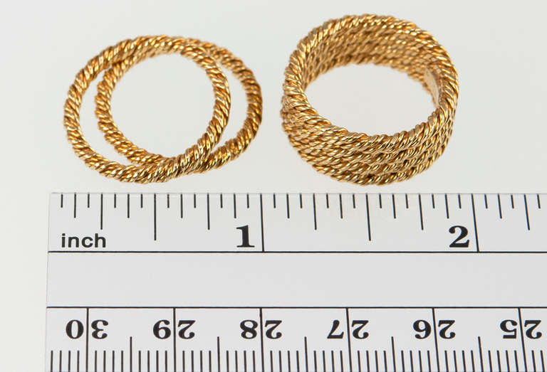 This gold ring stack that is both timeless and current! Tiffany & Co. 18 karat yellow gold woven stacking band rings.  Four bands are attached and two are separated- they all combine to a width of approximately 0.50 inches. Circa 1970s. Size 6.