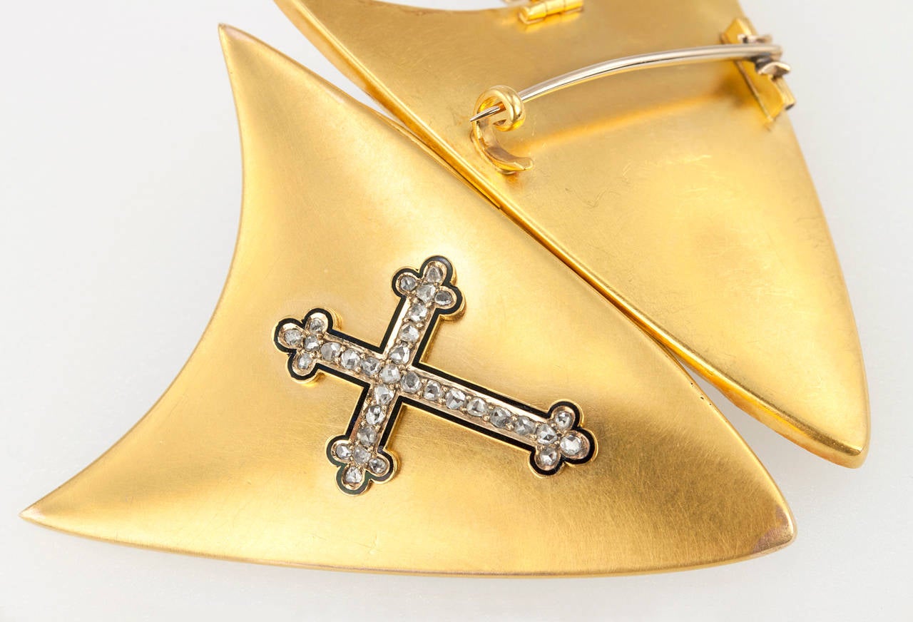 This rare, large locket is an incredible piece! A shield shaped double locket pendant in 18 karat yellow gold featuring an enamel cross with rose cut diamonds. Also, can be worn a  brooch with a pin attachment already in place in the back. Circa