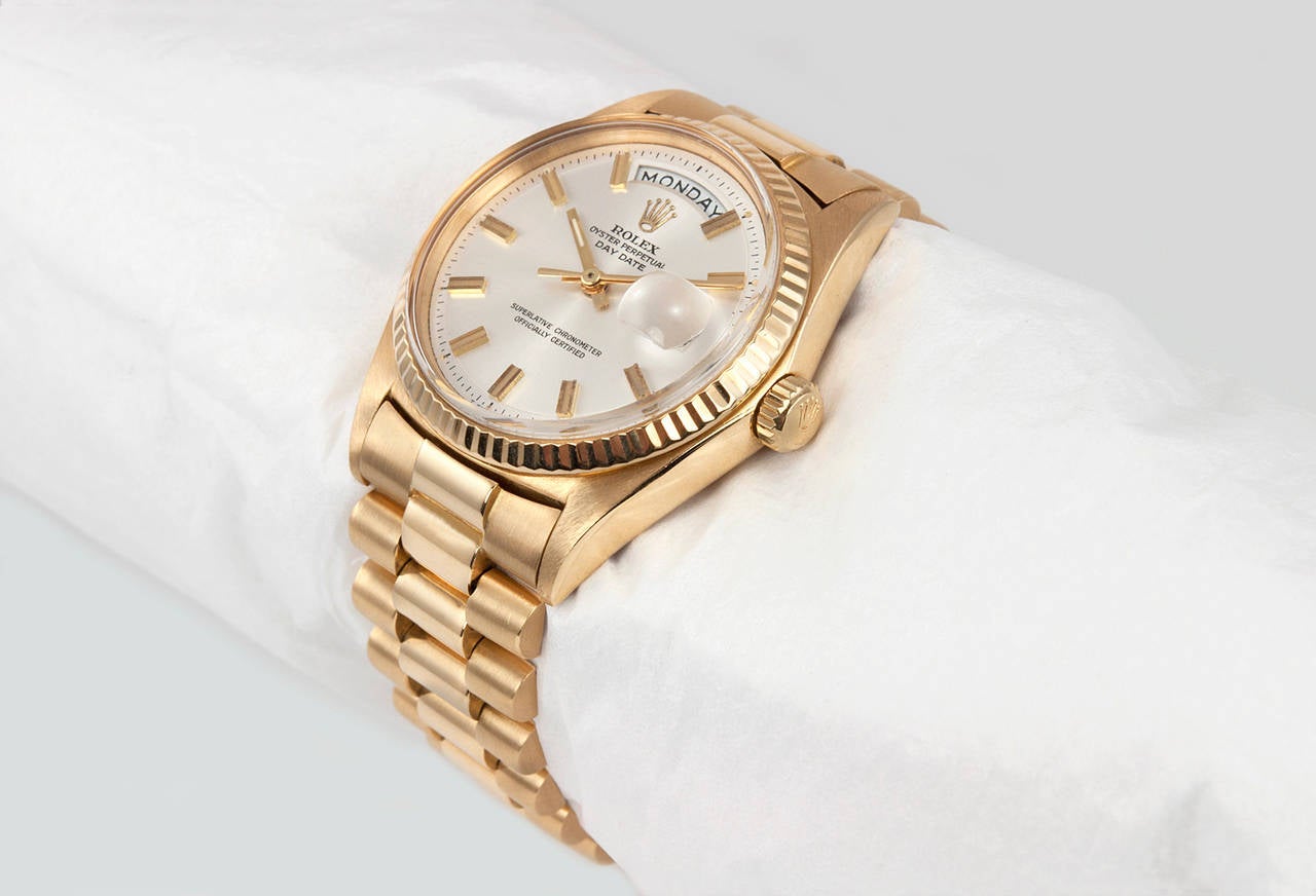 Rolex President 18 karat yellow gold wristwatch, reference 1803. This beautiful 1964 classic Rolex features a 18 karat yellow gold watch case and bracelet, original silvered dial with gold stick markers, plastic crystal, fluted 18K gold bezel, and a