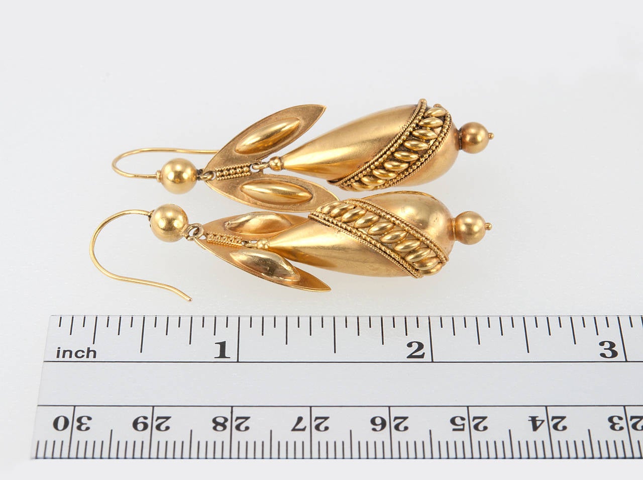 A very cool pair of Victorian 14 karat yellow gold dangle earrings. These earrings were made in the fashionable Archeological Revival styles that were popular around this time, circa 1870s-1890s. They feature lovely Etruscan Revival granulation
